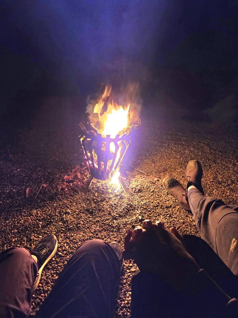 Feet up by a campfire at night