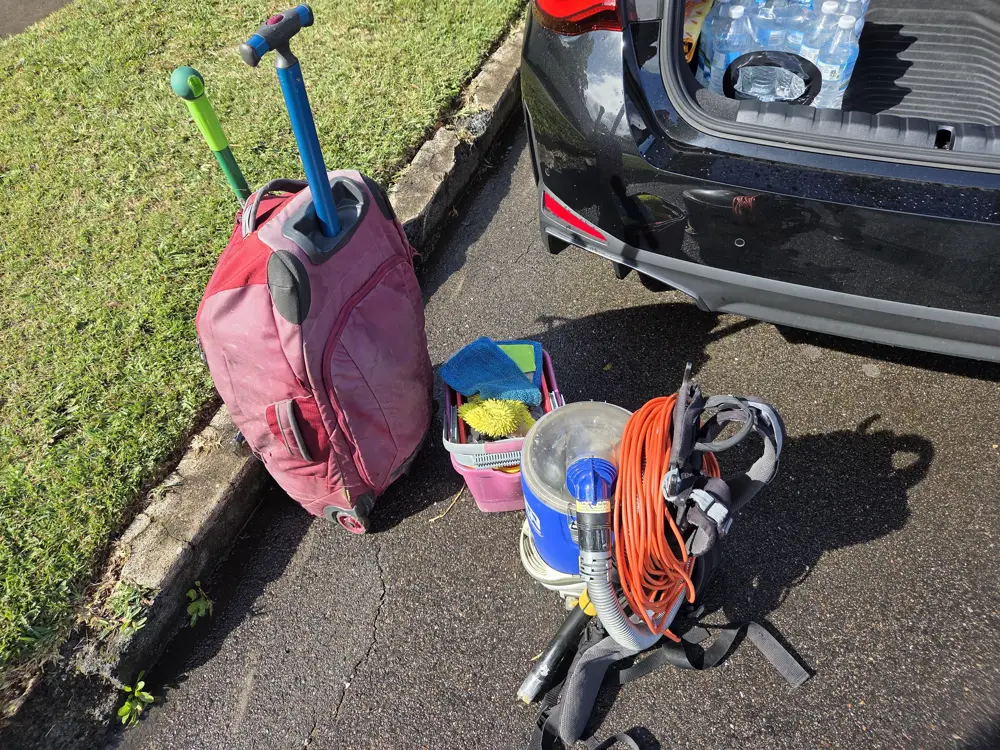 Cleaning kit and vacuum unloaded from a car boot